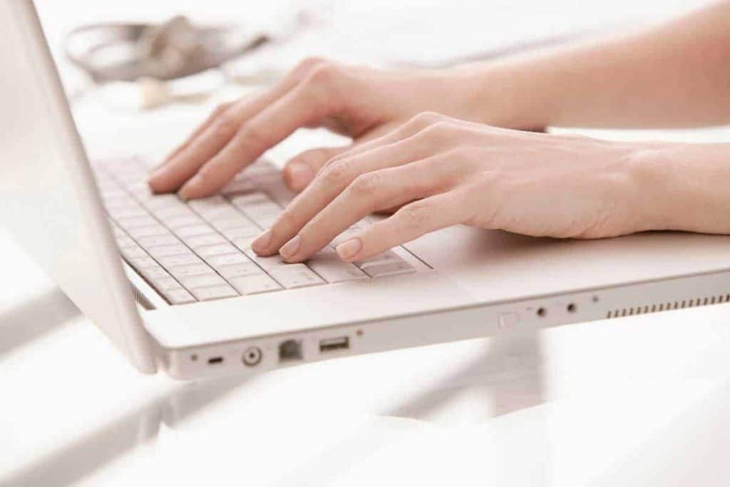 business website - Person typing on white laptop