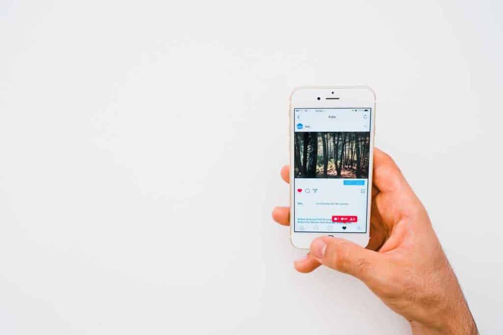 Person opening Instagram app with mobile phone