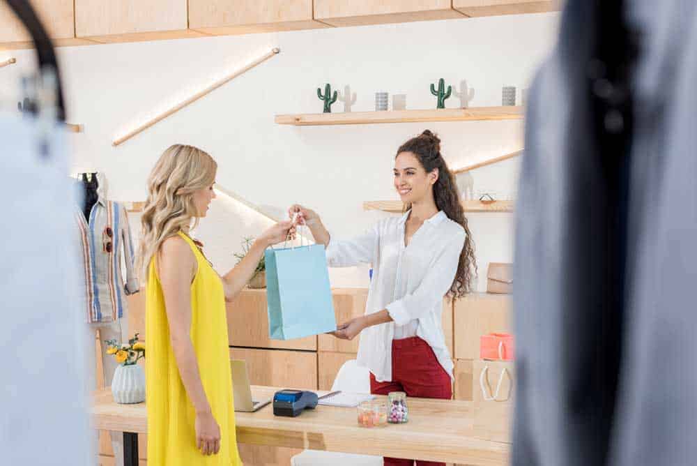 cashier giving customer her goods