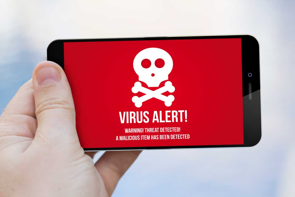 person holding mobile device with virus