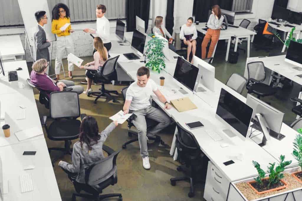 employees working in a coworking office to cut business costs