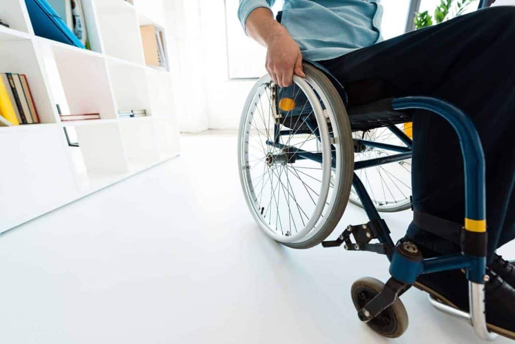 man in a wheelchair in an office Workplace for PWDs