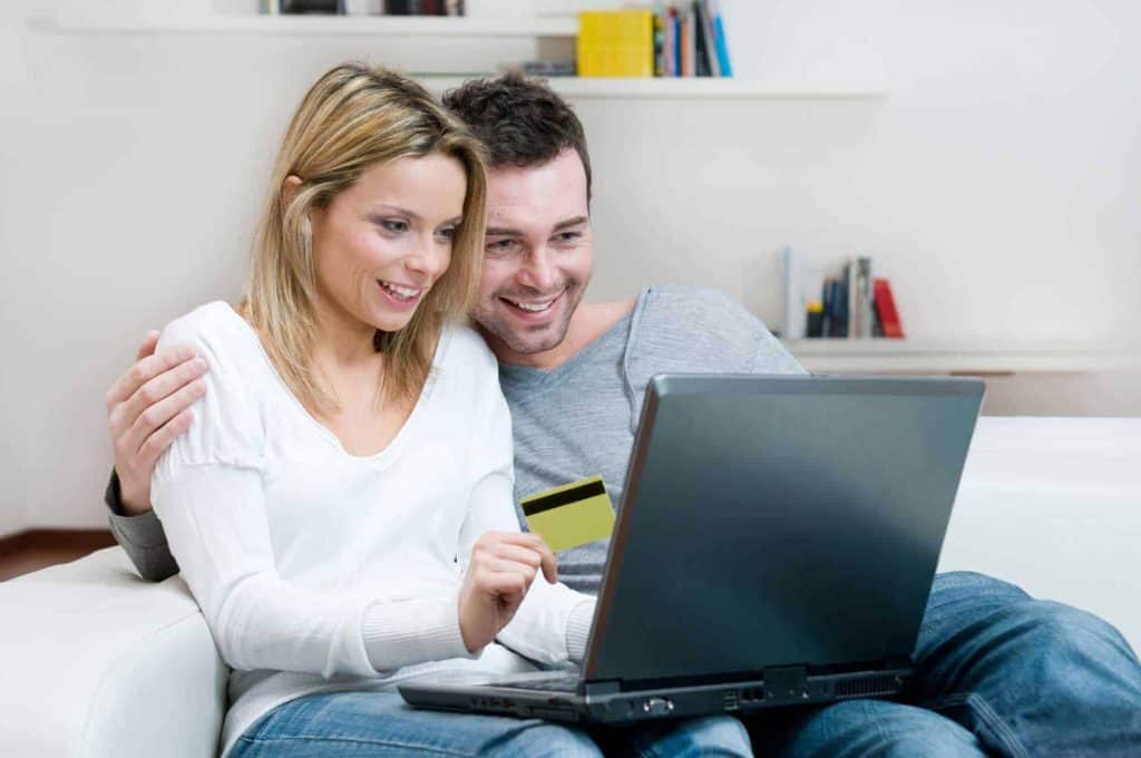 couple shopping online using social online payments for purchasing