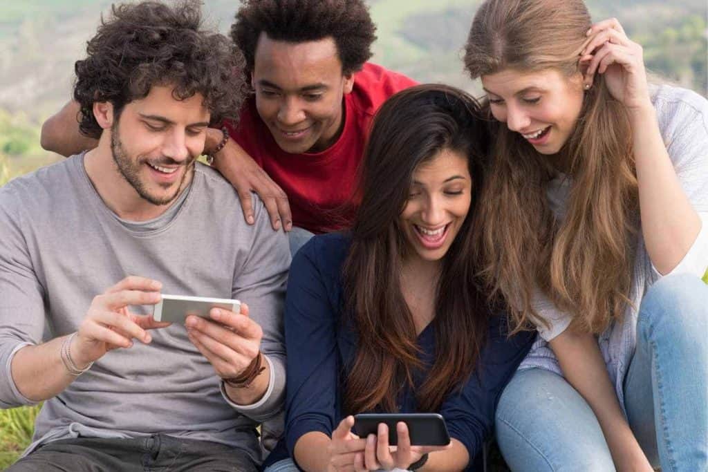 Friends looking at cellphone viral content