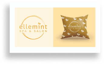 A heart-patterned pillow featuring the Element Spa and Salon logo.