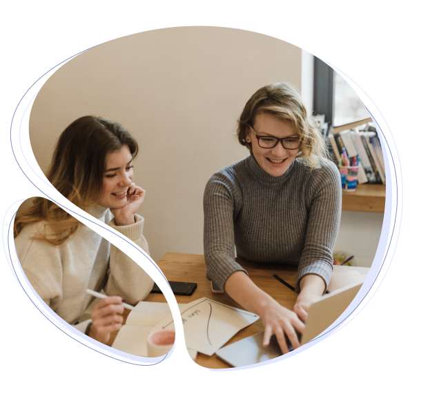 Two women at table working on small business SEO project.